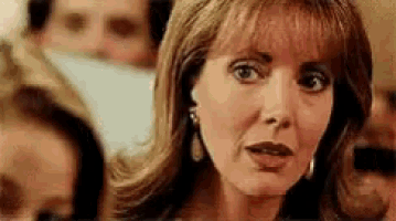 a close up of a woman 's face in a crowd .
