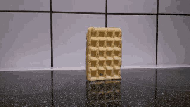 a waffle is sitting on top of a black counter
