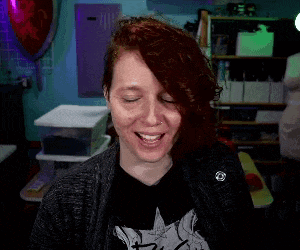 a woman with red hair is wearing a black shirt that says ' rock ' on it