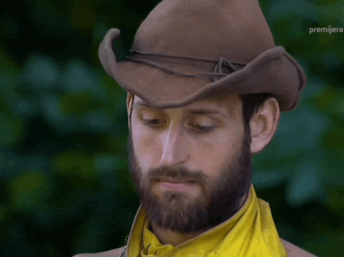 a man with a beard wearing a cowboy hat