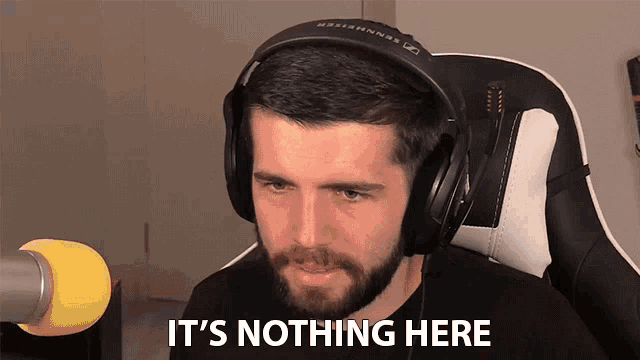 a man wearing headphones says it 's nothing here in front of a microphone