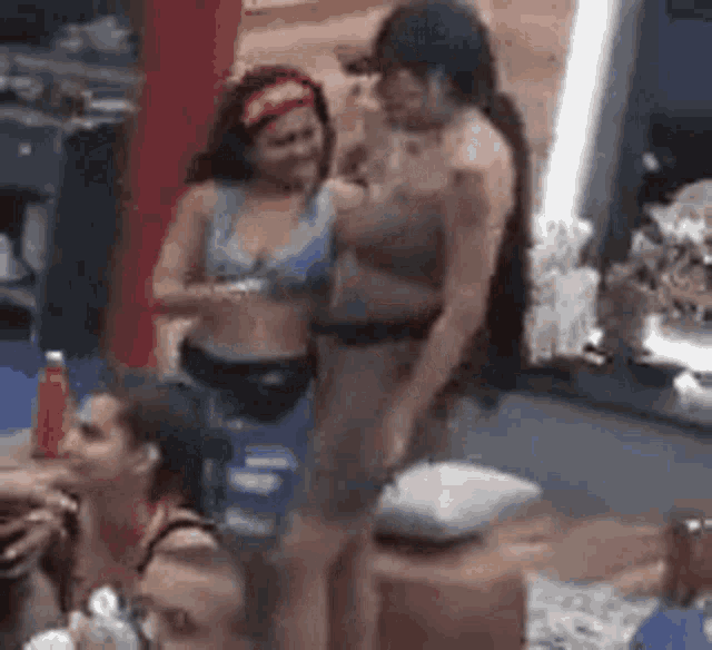 a group of women are standing next to each other in a room .