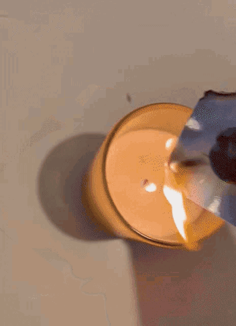 a candle is burning next to a picture of a person