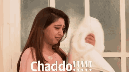 a woman is crying while holding a white pillow and the words chaddo !!! are above her head