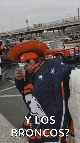 a man wearing a cowboy hat is holding a can of beer and asking y los broncos ?