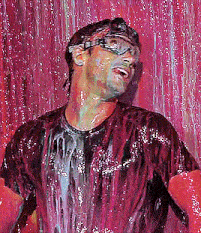 a man in a purple shirt is standing in front of a red wall