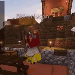 a person in a yellow jacket is sitting at a picnic table in a minecraft game .