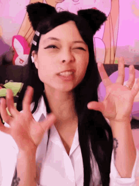 a woman wearing cat ears and a white shirt