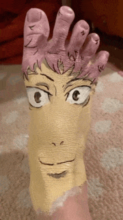 a person 's foot has been painted to look like a cartoon character