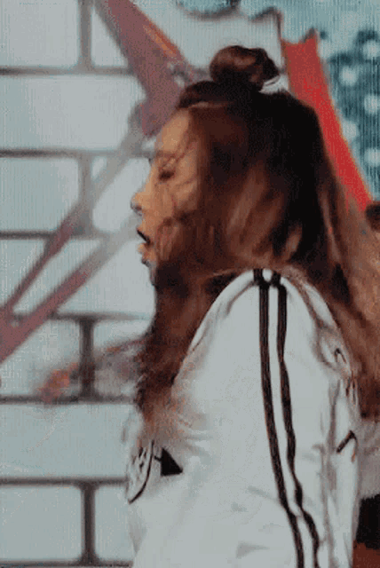 a woman in a white jacket with black stripes on the side