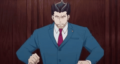 a man in a suit and tie is standing in front of a wooden wall with his hands up .
