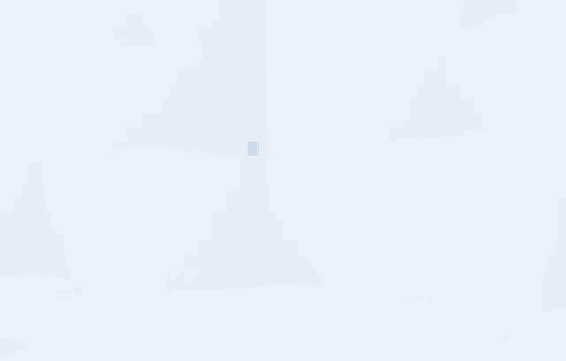 a cartoon penguin is standing in front of a snowy cliff .