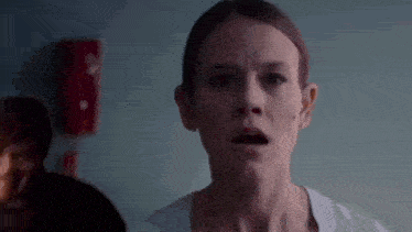 a woman with a surprised look on her face .