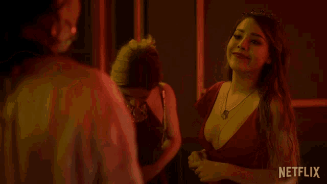 a woman in a red dress is being punched by another woman in a netflix ad
