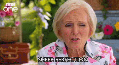 an older woman in a floral shirt is making a funny face and saying `` sheer perfection '' .
