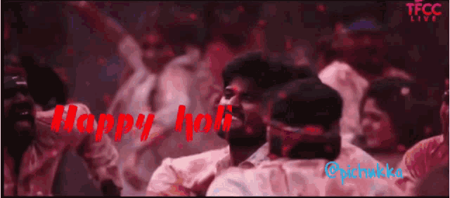 a group of people are dancing in a room with the words happy holi written in red
