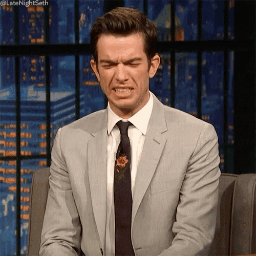 a man in a suit and tie is making a face .