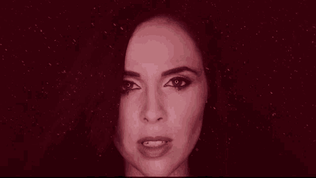 a close up of a woman 's face in a red light
