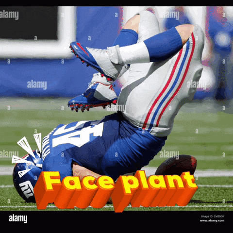 a new york giants football player is laying on his back on the field during a game