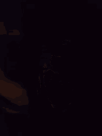 a close up of a man 's face in the dark .