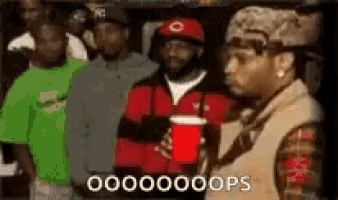 a group of men are standing next to each other and one of them is holding a red cup and says 00000oops .
