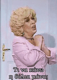 a woman in a pink jacket is standing in front of a door
