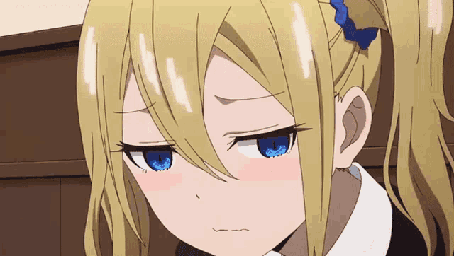 a girl with blonde hair and blue eyes is making a face
