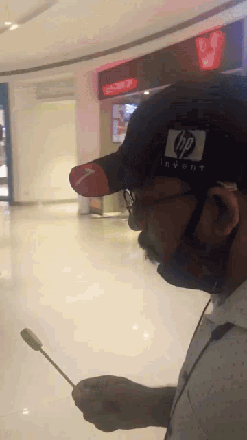 a man wearing a black hat with the hp logo on it