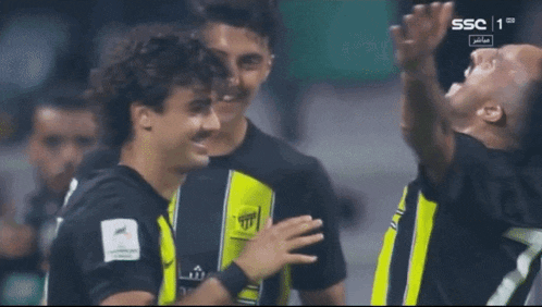 a group of soccer players are celebrating a goal with ssc 1 on the screen