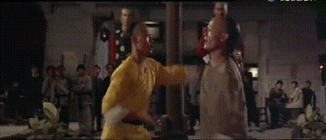 a man in a yellow shirt is holding a flower