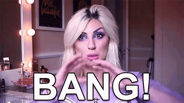 a woman is making a heart shape with her hands and bang is written in white letters