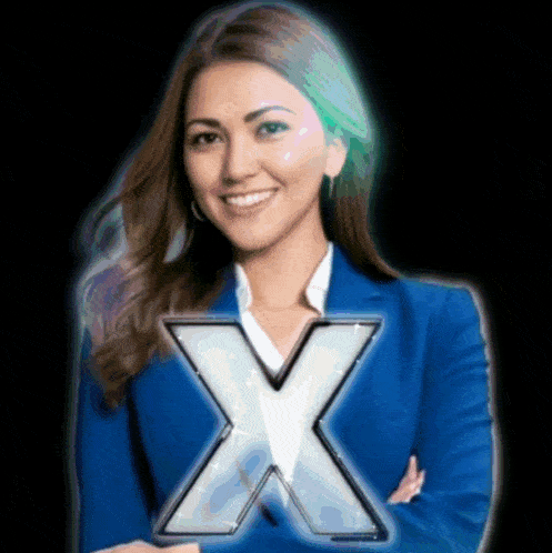 a woman in a blue jacket stands in front of an x