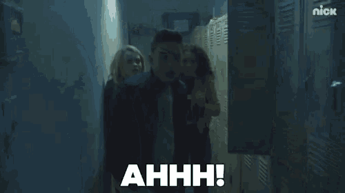 a man and a woman are standing next to each other in a locker room and the man is saying ahhh .