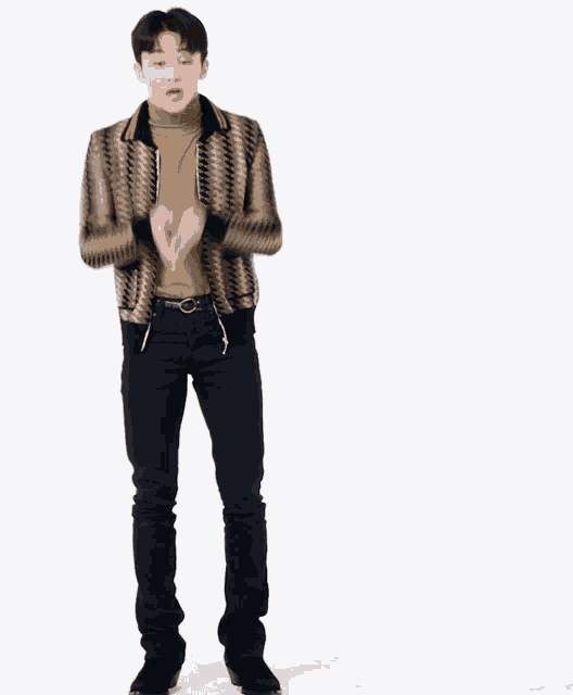a man wearing a striped jacket and black pants is standing in front of a white background