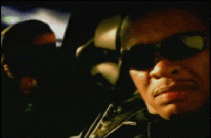 a man wearing sunglasses is sitting in a car with a child in the back seat