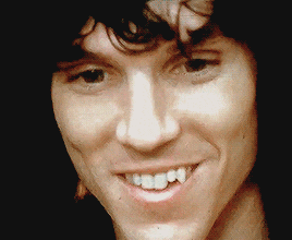 a close up of a man 's face with his mouth open