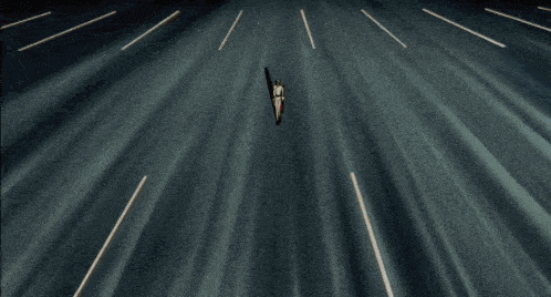 a person is riding a motorcycle down a road