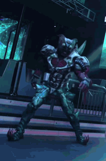 a man in a monster costume is standing in a dark room