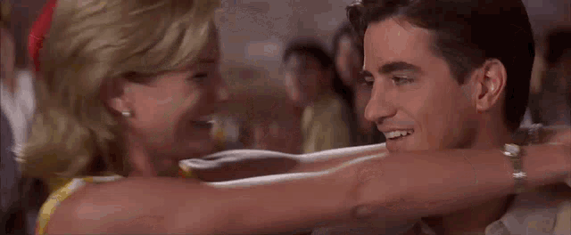 a man and a woman are dancing together in a club .