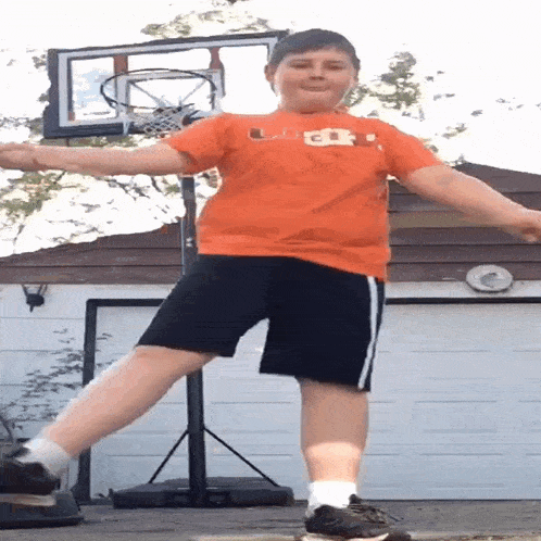 a boy wearing an orange shirt that says ucsd on it