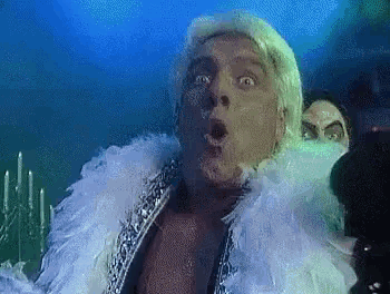 a man with blonde hair is wearing a white feather boa around his neck