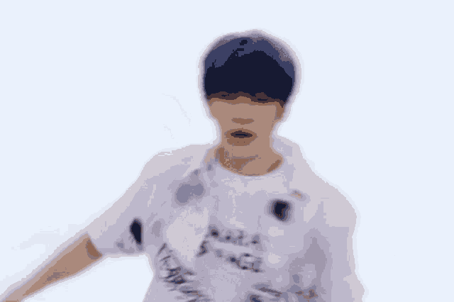 a blurry picture of a man with blue hair wearing a white shirt
