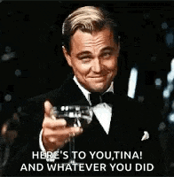 a man in a tuxedo is toasting with a glass of wine .