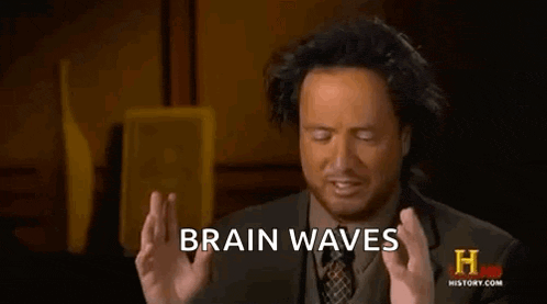 a man in a suit and tie is making a funny face and saying `` brain waves '' .