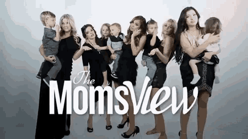 a group of women standing next to each other holding children in front of a sign that says the momsview
