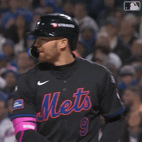 a mets player is swinging a bat at a ball