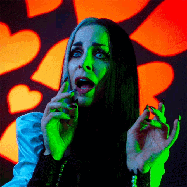 Bite Finger Lily Munster GIF - Bite Finger Lily Munster Sheri Moon Zombie GIFs