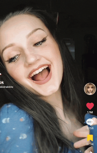 a woman 's face is displayed on a tiktok app with the number 1.1m at the top