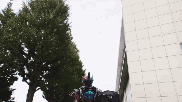 a person in a robot costume stands in front of a white building