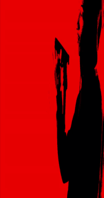a silhouette of a person laying on their back with a red background